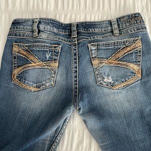 Silver Twisted distressed denim boot cut mid rise jeans.